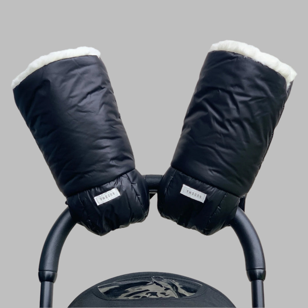 Black hUDOMA pram gloves attached to a pushchair handle with the faux fur lining visible